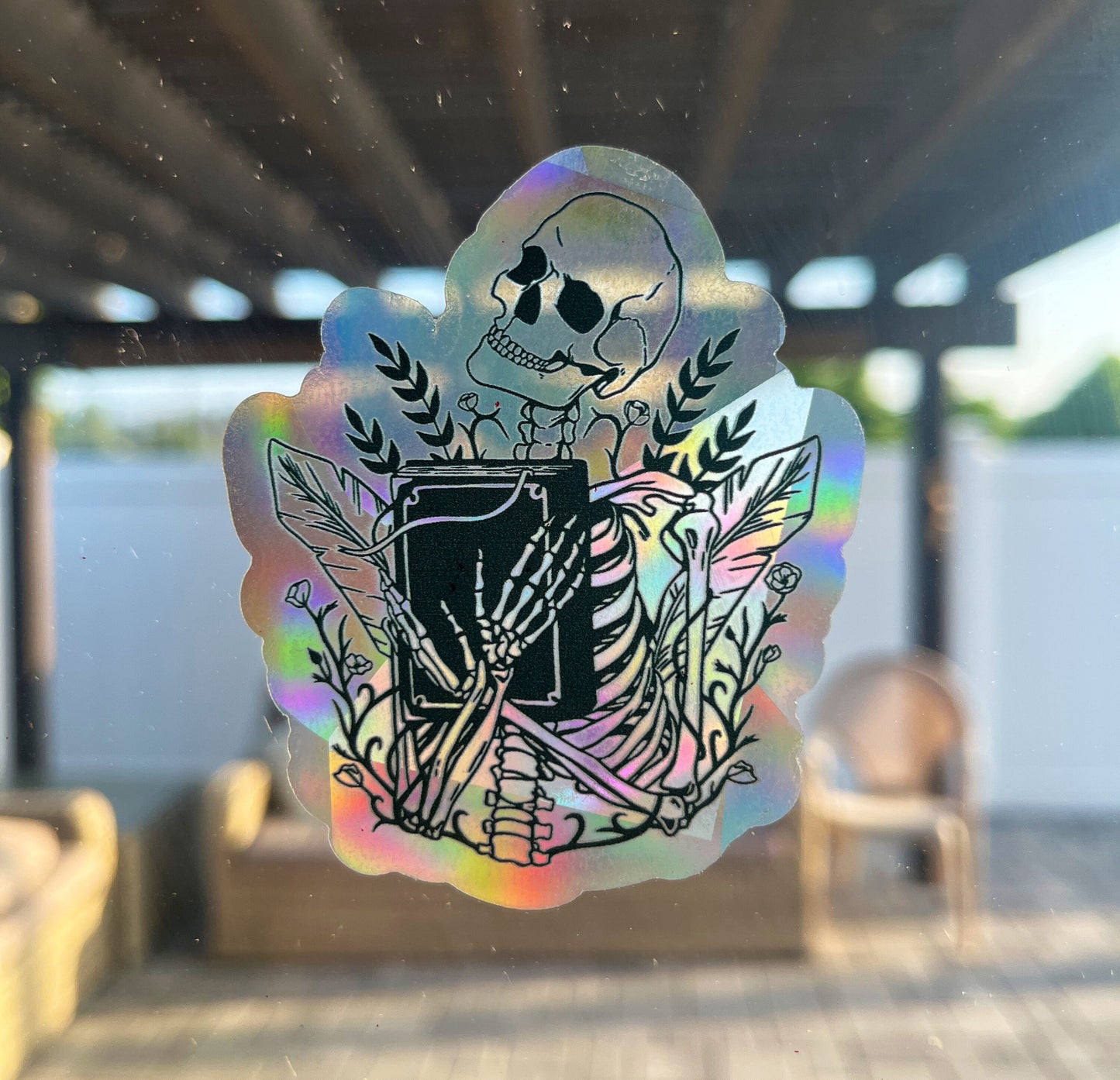 Skull holding book Sun Catcher