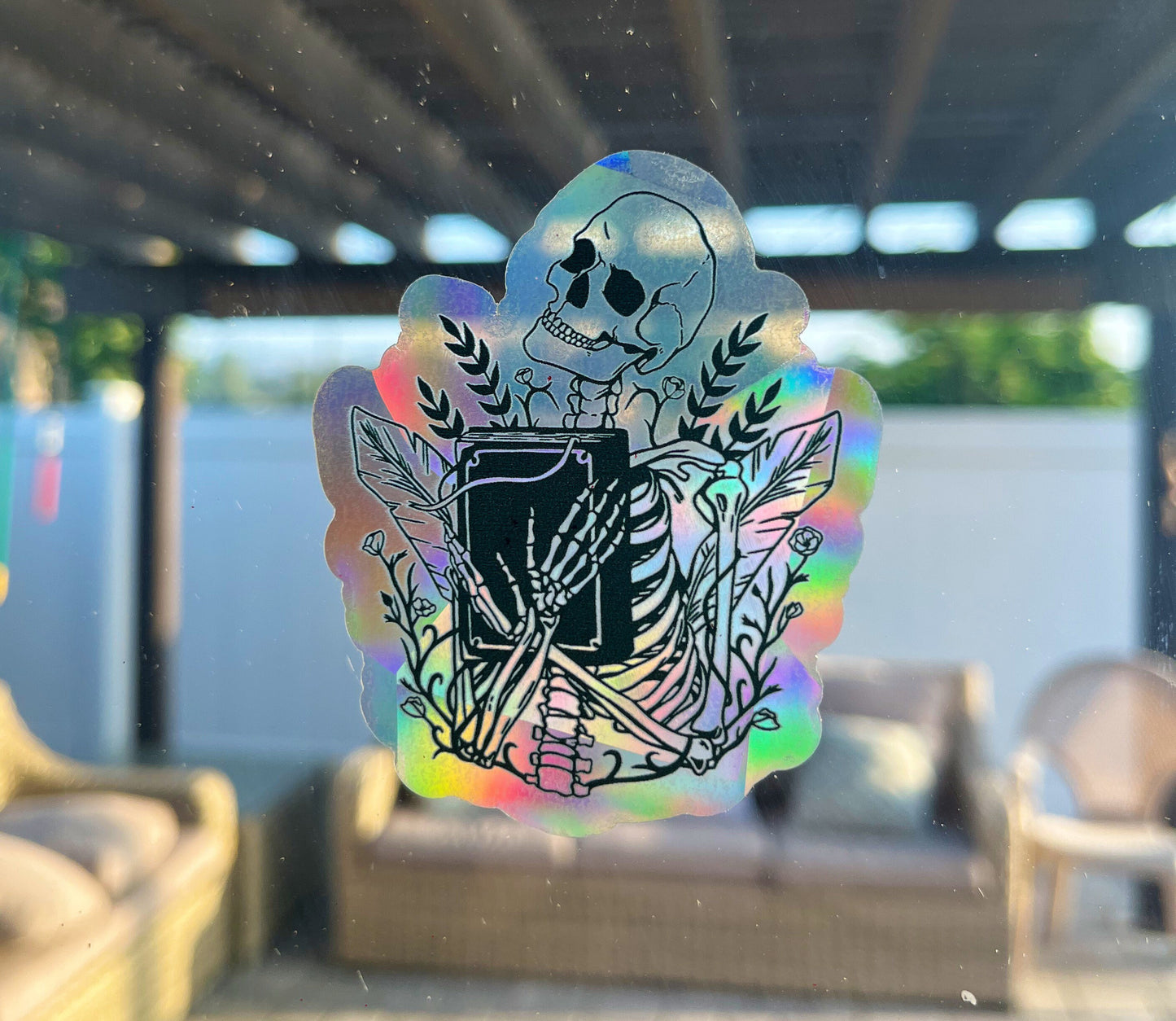 Skull holding book Sun Catcher